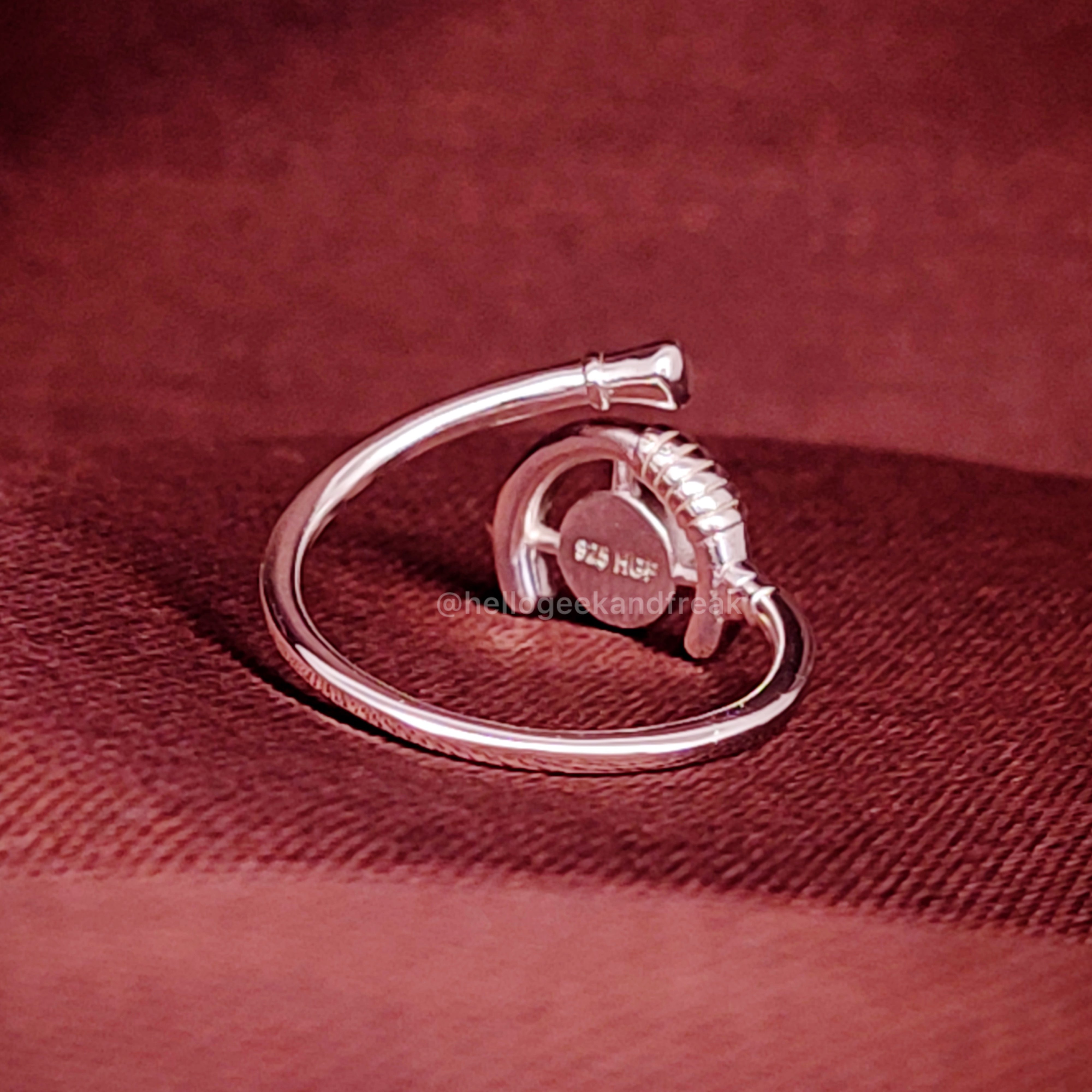 Anillo con aro metálico plateado y piedra ámbar en engaste curvo