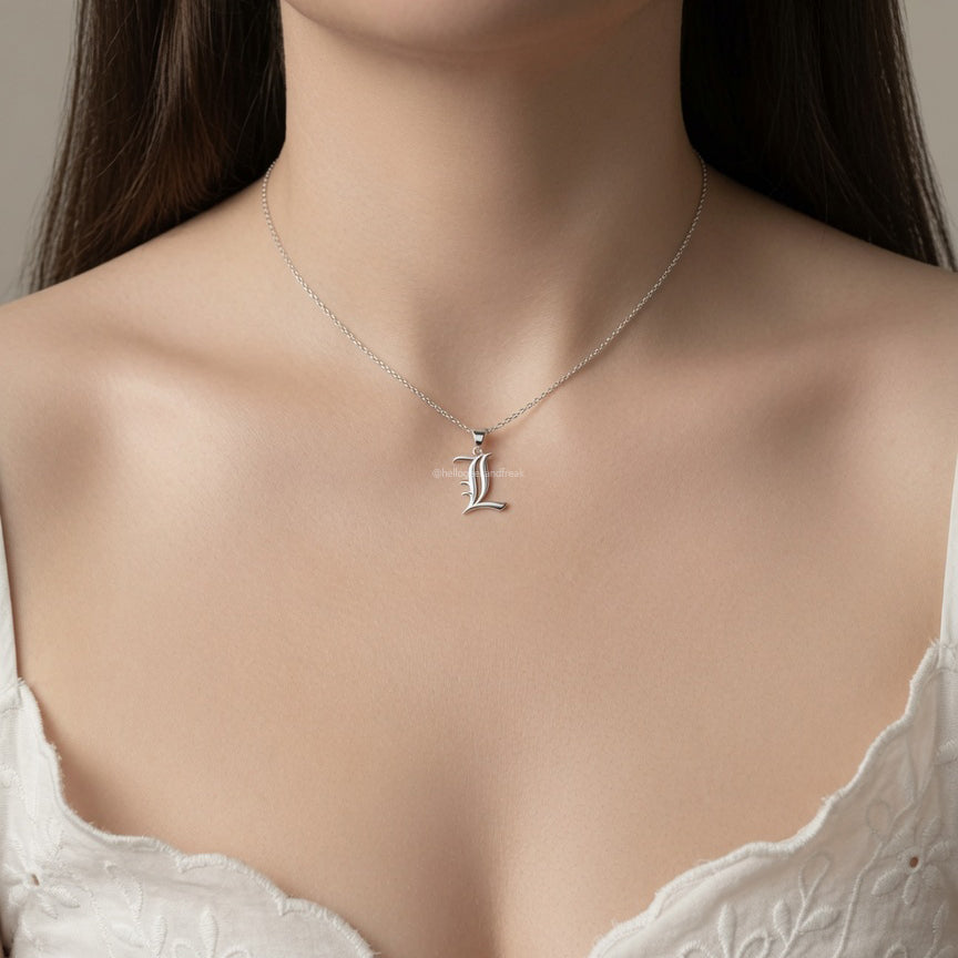 Collar con colgante letra L plateada centrado en el cuello