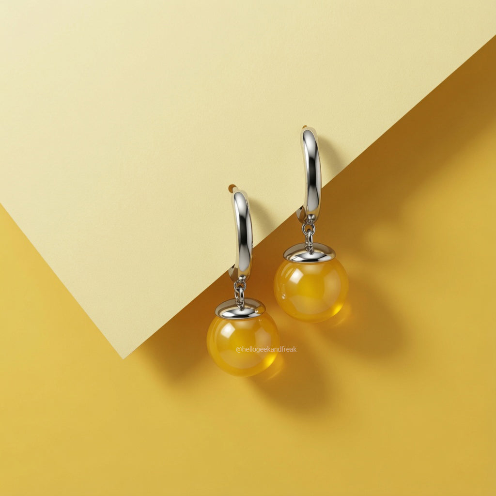 Pendientes con aro plateado y colgante esférico amarillo, con detalle circular superior